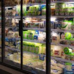 A wide selection of dairy and plant-based products in a supermarket refrigerated section.
