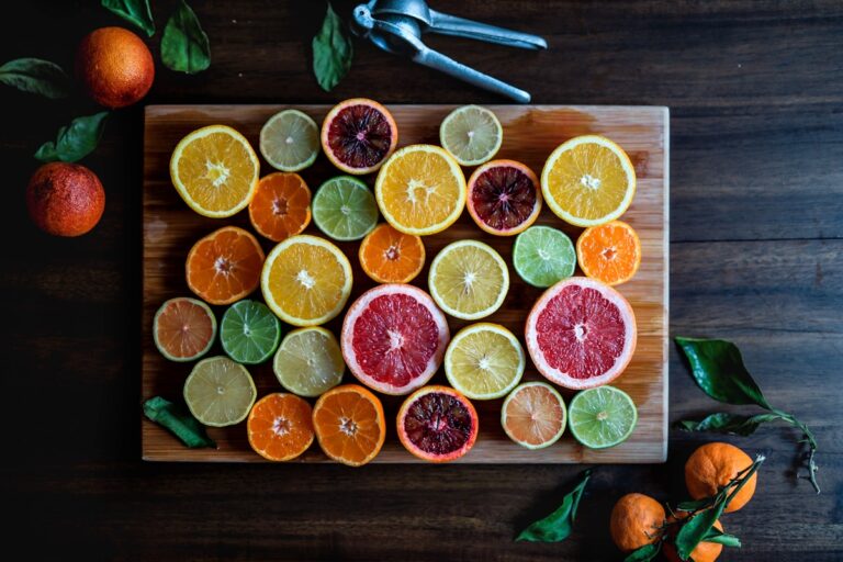 assorted sliced citrus fruits on brown wooden chopping board