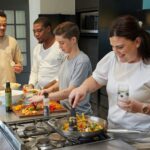 a group of people preparing food in a kitchen
